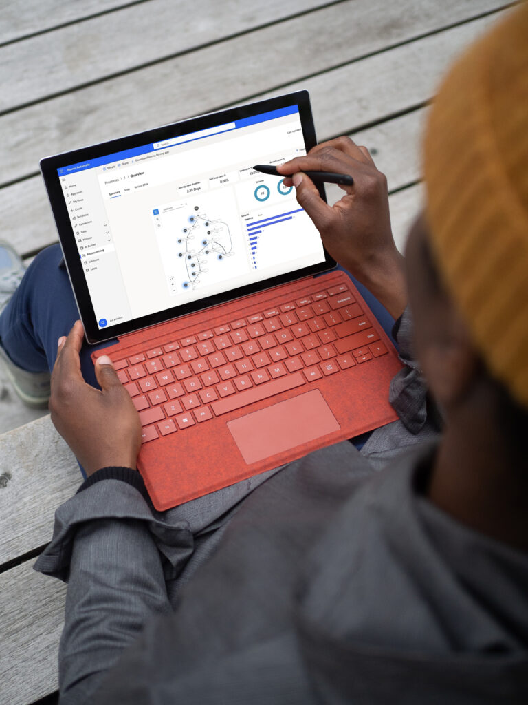 power automate red microsoft surface laptop mockup held in a users lap